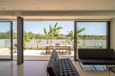 a living room with a couch and a table at Luxury Villa Glass - 200 meters From The Beach no6 in Daratso