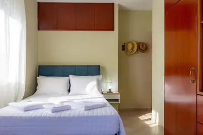 a bedroom with a bed with two towels on it at Casa Anthea 3 bedroom apartment with Garden in Kounoupidhianá