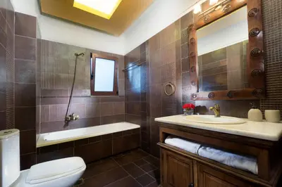 a bathroom with a sink and a tub and a toilet at Villa Litsarda in Litsárdha