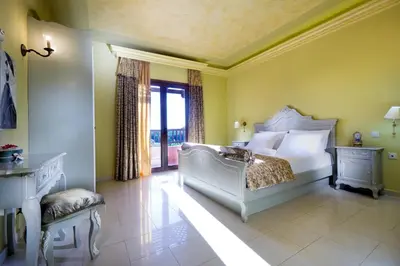 a bedroom with a white bed and a window at Villa Litsarda in Litsárdha