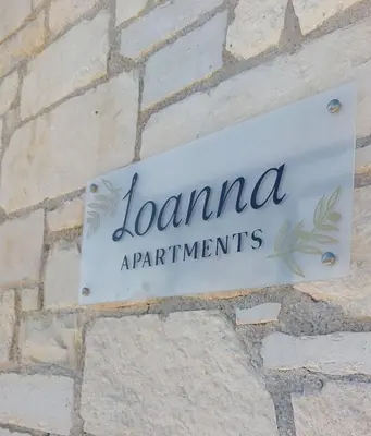 a sign on the side of a brick wall at Ioanna Apartment 2 in Chania Town