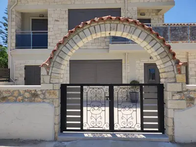 a gate in front of a house with an arch at Ioanna Apartment 2 in Chania Town
