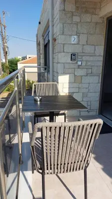 a black table and two chairs on a patio at Ioanna Apartment 2 in Chania Town