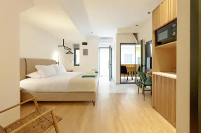 a bedroom with a bed and a living room with a tv at Evridiki Apartment in Chania Town