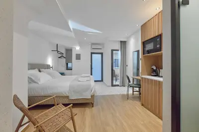 a bedroom with a bed and a desk with a chair at Evridiki Apartment in Chania Town