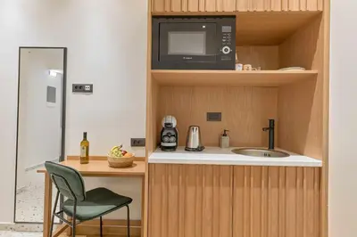 a small kitchen with a sink and a microwave at Evridiki Apartment in Chania Town