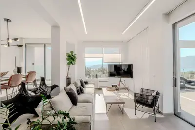 a living room with a couch and a tv at Sunny Vacay Villa in Stérnai