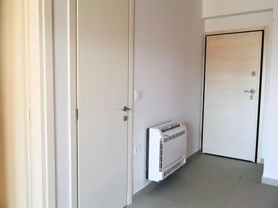 a small room with a heater and a door at Hellene Αpartment near Chania City Centre in Chania Town
