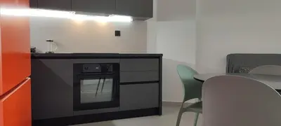 a kitchen with a stove and a table with chairs at Hellene Αpartment near Chania City Centre in Chania Town