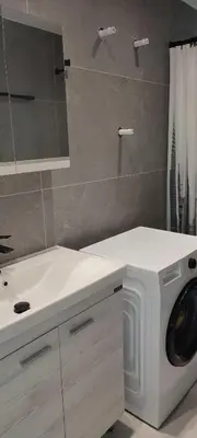 a bathroom with a washing machine and a sink at Hellene Αpartment near Chania City Centre in Chania Town