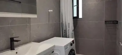 a bathroom with a sink and a washing machine at Hellene Αpartment near Chania City Centre in Chania Town