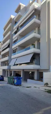 a large apartment building with two trash cans in front of it at Hellene Αpartment near Chania City Centre in Chania Town