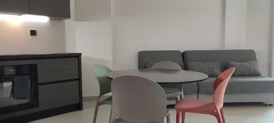 a living room with a couch and a table and chairs at Hellene Αpartment near Chania City Centre in Chania Town