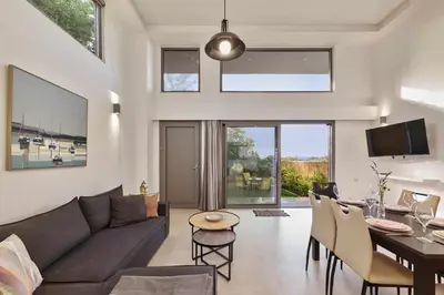 a living room with a couch and a dining room at Renia's house in Daratso