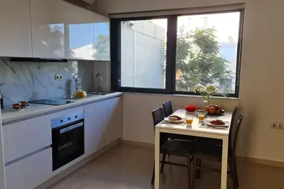 a kitchen with a small table and a table and chairs at Luxury apartment in the heart of the city in Chania Town