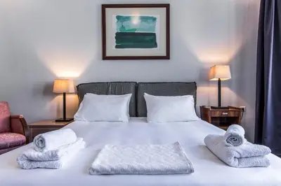 a bedroom with a bed with towels on it at Casa Ari - Venetian Port in Chania Town