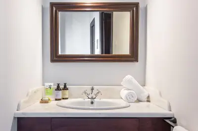a bathroom with a sink and a mirror at Casa Ari - Venetian Port in Chania Town