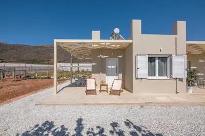 a house with two chairs and a patio at Koutris Apartment 2 in Falasarna