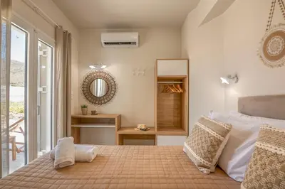 a bedroom with a large bed and a mirror at Koutris Apartment 2 in Falasarna