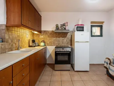 a kitchen with a white refrigerator and a sink at The Hillside Home in Plataniás