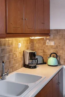 a kitchen counter with a sink and a microwave at The Hillside Home in Plataniás
