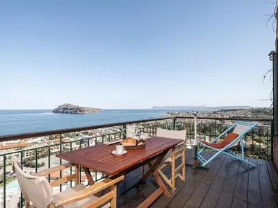 a table and chairs on a balcony with the ocean at The Hillside Home in Plataniás