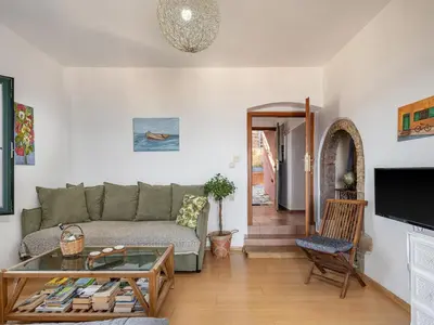 a living room with a couch and a table at The Hillside Home in Plataniás