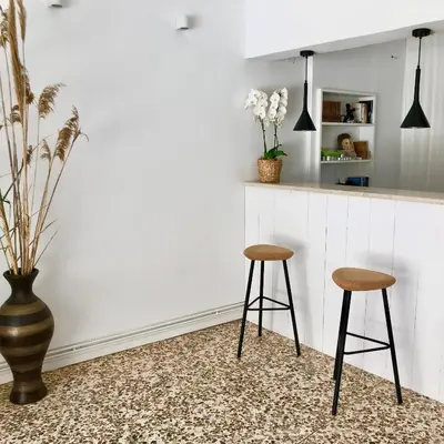 a kitchen with two stools in front of a counter at Cloudberry in Kalyves
