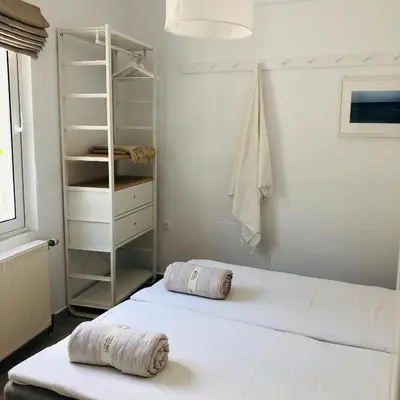 a bedroom with a white bed with two pillows on it at Cloudberry in Kalyves