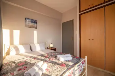 a bedroom with a bed with towels on it at Sea Gem family in Chania Town