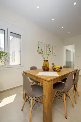 a dining room with a wooden table and chairs at Callisto House in Kalyves in Kalyves
