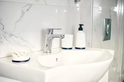 a bathroom sink with a soap dispenser on it at Callisto House in Kalyves in Kalyves