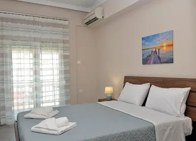 a bedroom with a large bed and a window at eleftheria's apartment in Chania Town