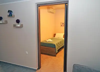 a small bedroom with a bed and a mirror at eleftheria's apartment in Chania Town