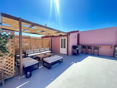 a patio with a couch and tables on a building at Venetian Kamara in Old Town Chania in Chania Town