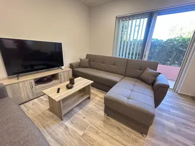 a living room with a couch and a flat screen tv at Venetian Kamara in Old Town Chania in Chania Town