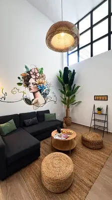 a living room with a black couch and a table at Central City Loft by NEK in Chania Town