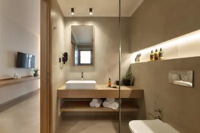 a bathroom with a sink and a mirror at Inea Sole Boutique Hotel in Kato Daratso
