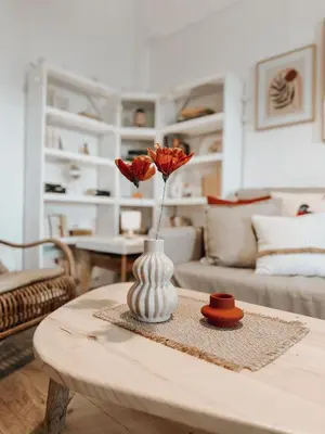a vase with flowers on a table in a living room at Stella's Boho Retreat in Palaiochóra