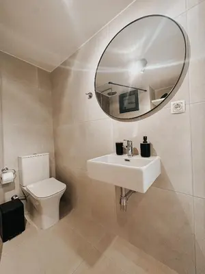 a bathroom with a white sink and a mirror at Stella's Boho Retreat in Palaiochóra