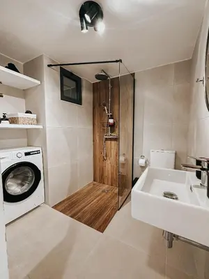 a bathroom with a washing machine and a sink at Stella's Boho Retreat in Palaiochóra