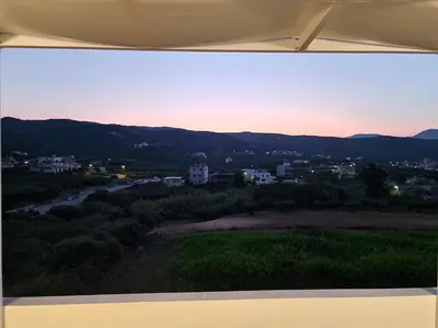 a view of a city at sunset from a tent at S n G/ Best view apartment in Kissamos