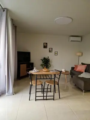 a living room with a table and chairs and a couch at S n G/ Best view apartment in Kissamos