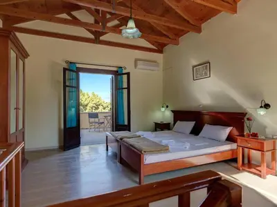 a bedroom with a large bed in a room at Group accommodation in Crete separate houses in Douliana