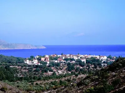 a town on a hill next to the water at Group accommodation in Crete separate houses in Douliana