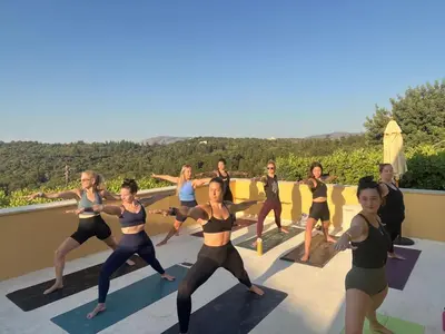 a group of women doing yoga on a roof at Group accommodation in Crete separate houses in Douliana