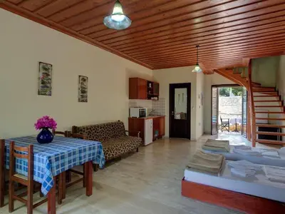 a living room with a table and a couch at Group accommodation in Crete separate houses in Douliana