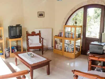 a living room filled with furniture and a tv at Group accommodation in Crete separate houses in Douliana