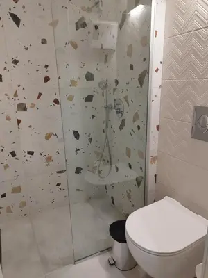 a bathroom with a shower and a toilet in it at Cozy Studio in the Heart of Chania in Chania Town