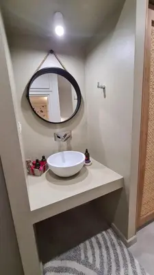 a bathroom with a white sink and a mirror at Cozy Studio in the Heart of Chania in Chania Town